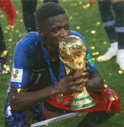 French player holding World Cup trophy