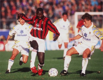 George Weah with the ball on football pitch